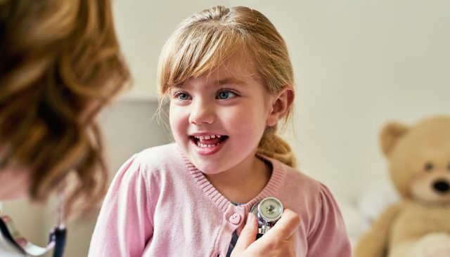 Young girl being examined by a healthcare provider