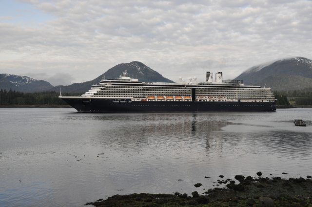 A cruise ship floating in the waters off of Ketchikan, Alaska with a cloudy gray sky in the background
