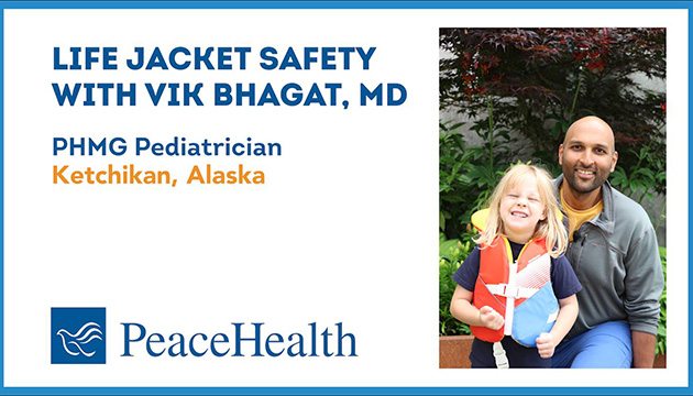 Dr. Vik Bhagat and a young helper demonstrate basics on life jackets