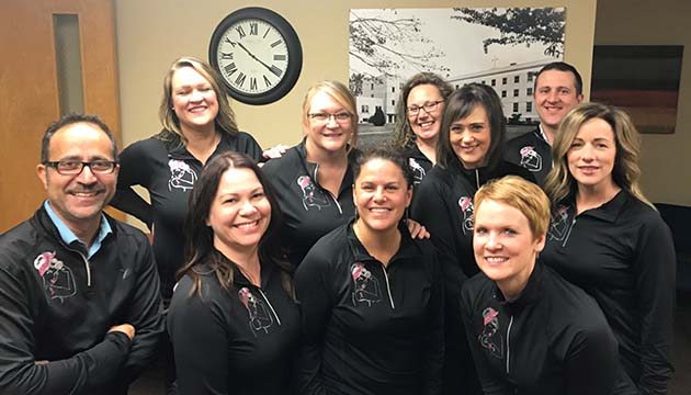 Lisa Boswell and team wear breast cancer awareness jackets