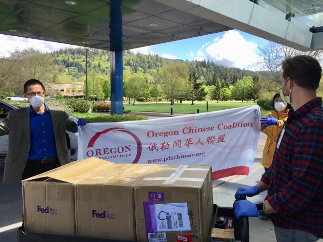Qusheng Jin and Qing Lu, members of the Oregon Chinese Coalition, deliver donated N95 masks for frontline workers at PeaceHealth Sacred Heart Medical Center at RiverBend in Springfield, Ore. 